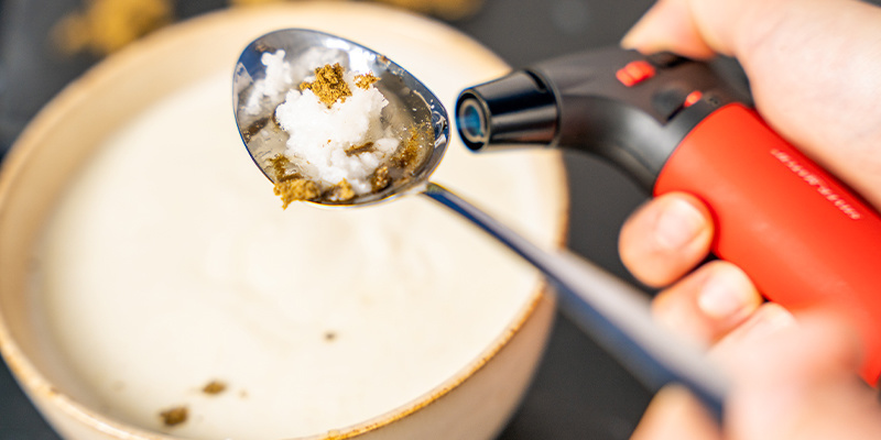 Next, take a lighter and (carefully) heat the bottom of the spoon.